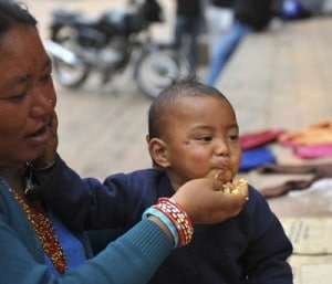 Nepalese-woman-feeds-her-son_400